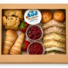 Small kraft window platter box filled with sandwiches, scones and preserve pots