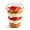 Clear domed cup lid without a straw slot covering a fruit dessert