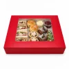 Red window platter box filled with sandwiches, cakes and afternoon tea treats