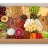 Open large kraft platter tray displaying cheese and charcuterie
