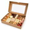 Large open hinged kraft window platter box filled with sandwiches and snacks